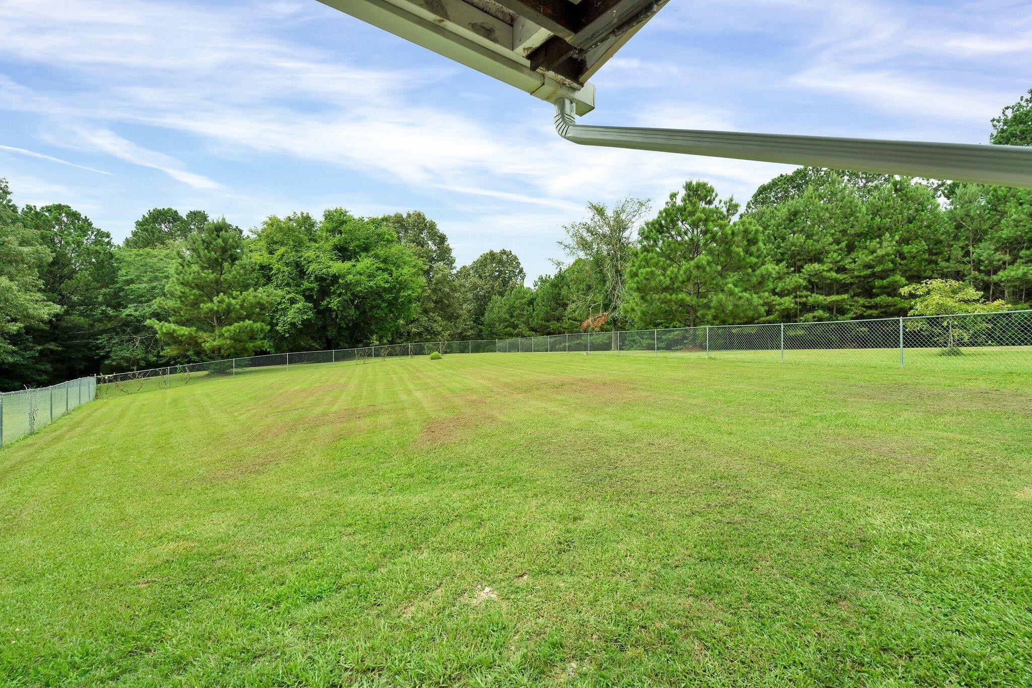 2131 Southeast Hunt Road Cleveland, TN 37323 - Photo 30 of 38 a view of a yard with a wooden fence