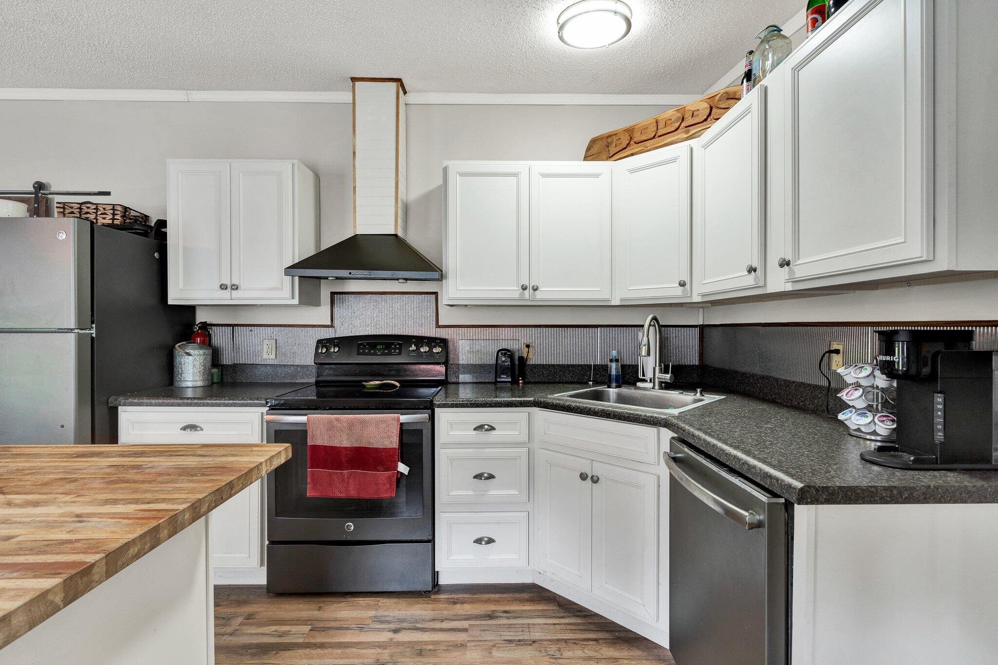 2131 Southeast Hunt Road Cleveland, TN 37323 - Photo 6 of 38 a kitchen with stainless steel appliances granite countertop a stove and a refrigerator