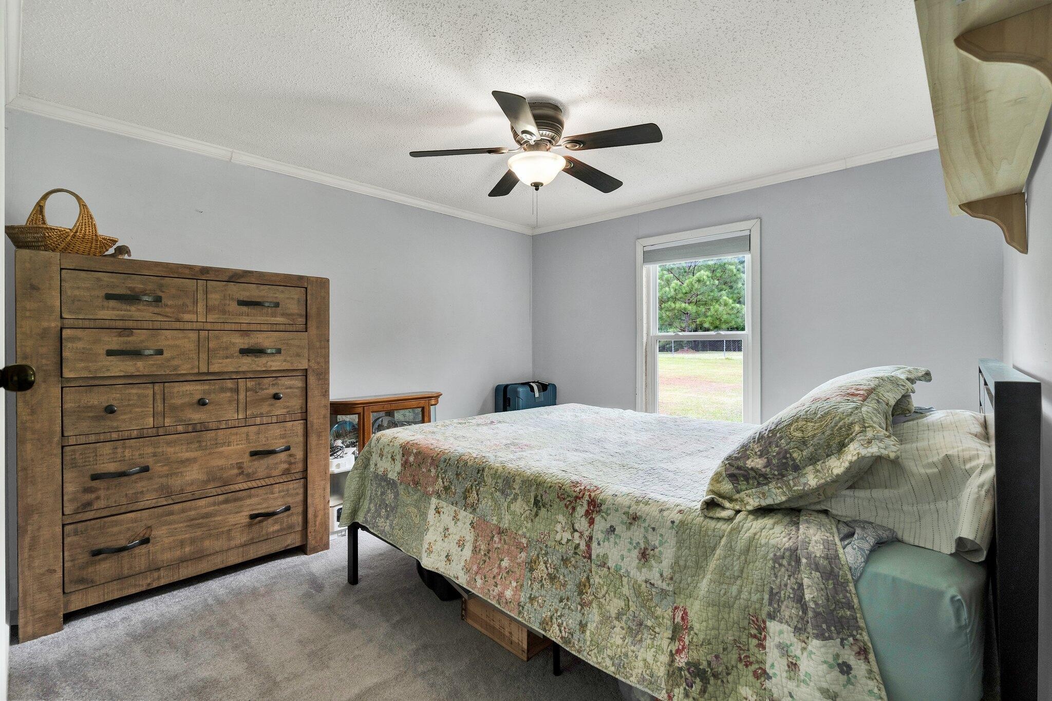 2131 Southeast Hunt Road Cleveland, TN 37323 - Photo 10 of 38 a bedroom with a bed and a chandelier