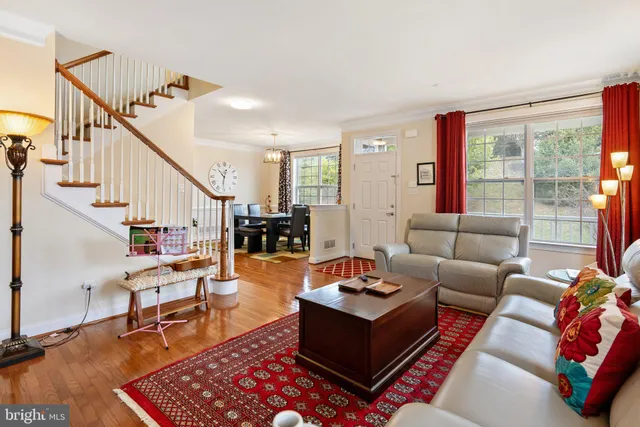 a living room with furniture a large window and a fireplace