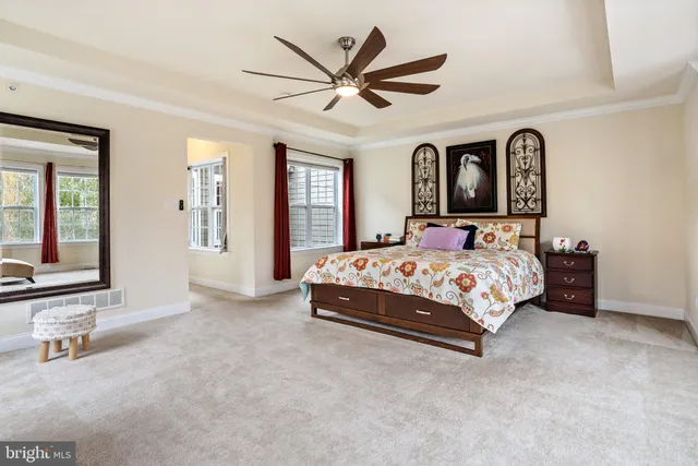 a bed sitting in a room next to a window