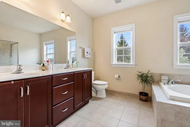 a bathroom with a tub shower and a sink