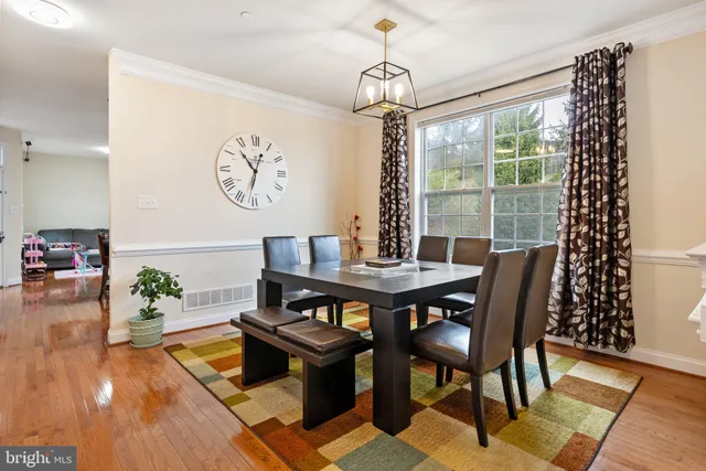 a living room with furniture a rug and a large window