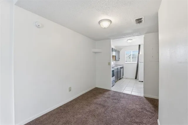 a view of a kitchen cabinets and a refrigerator