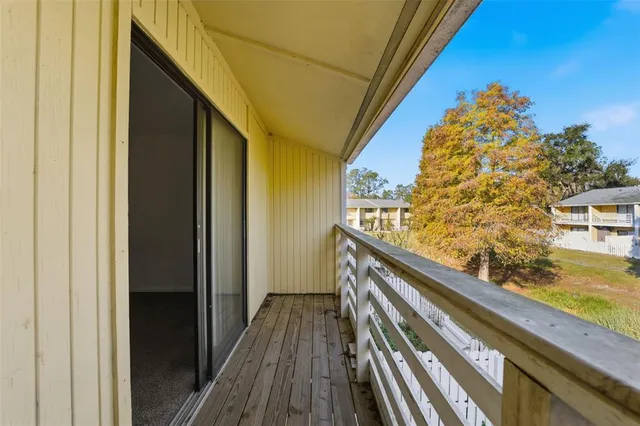a view of balcony with wooden floor