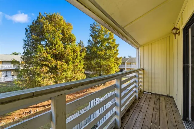 a view of balcony with wooden floor