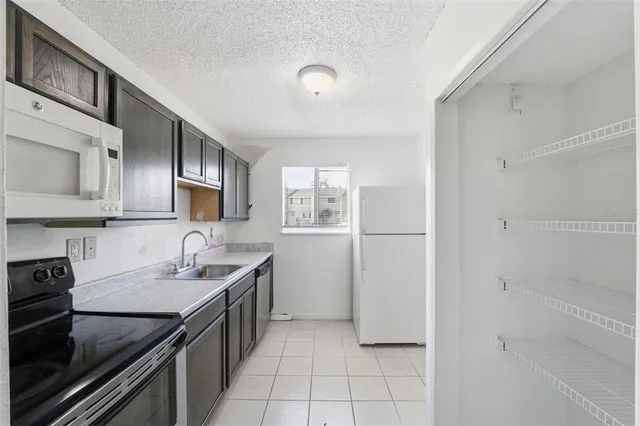 a kitchen with a sink appliances and cabinets