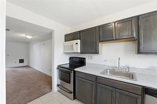 a kitchen with a sink and cabinets