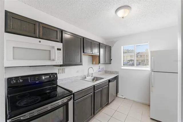 a kitchen with a sink stove and microwave