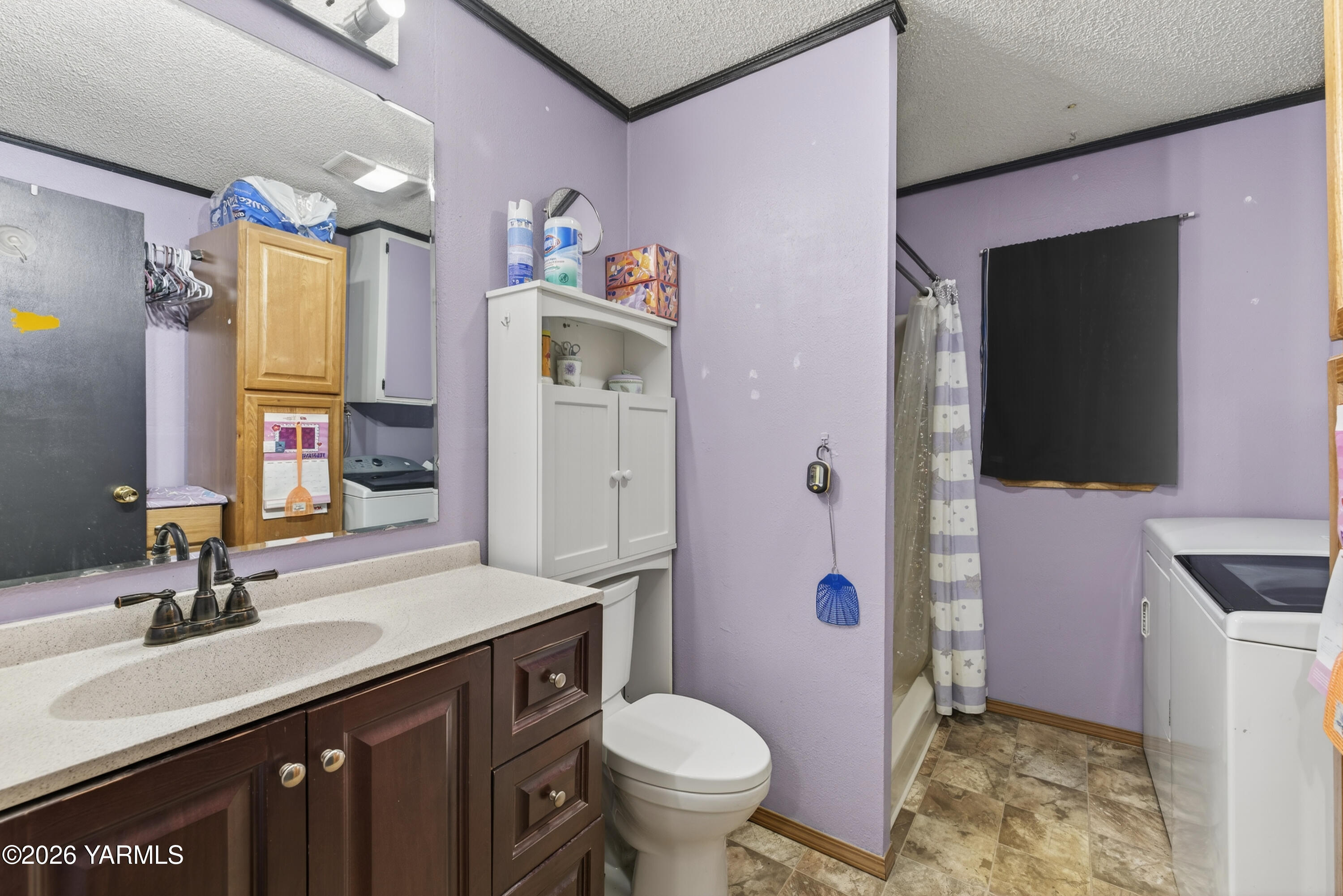 232 6th Avenue Mabton, WA 98935 - Photo 12 of 35 a bathroom with a granite countertop toilet sink and mirror