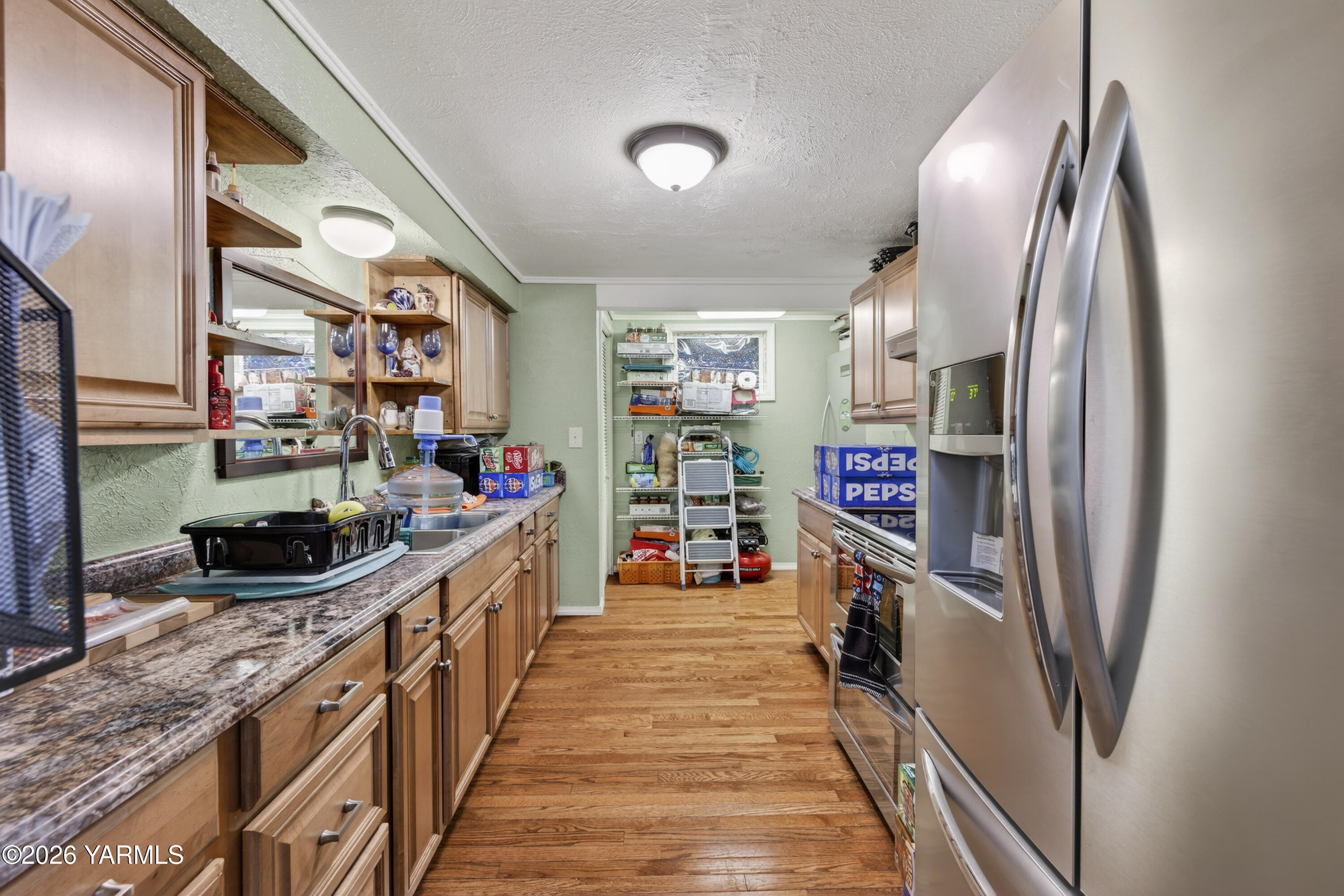 232 6th Avenue Mabton, WA 98935 - Photo 8 of 35 a kitchen with stainless steel appliances granite countertop a refrigerator and a stove