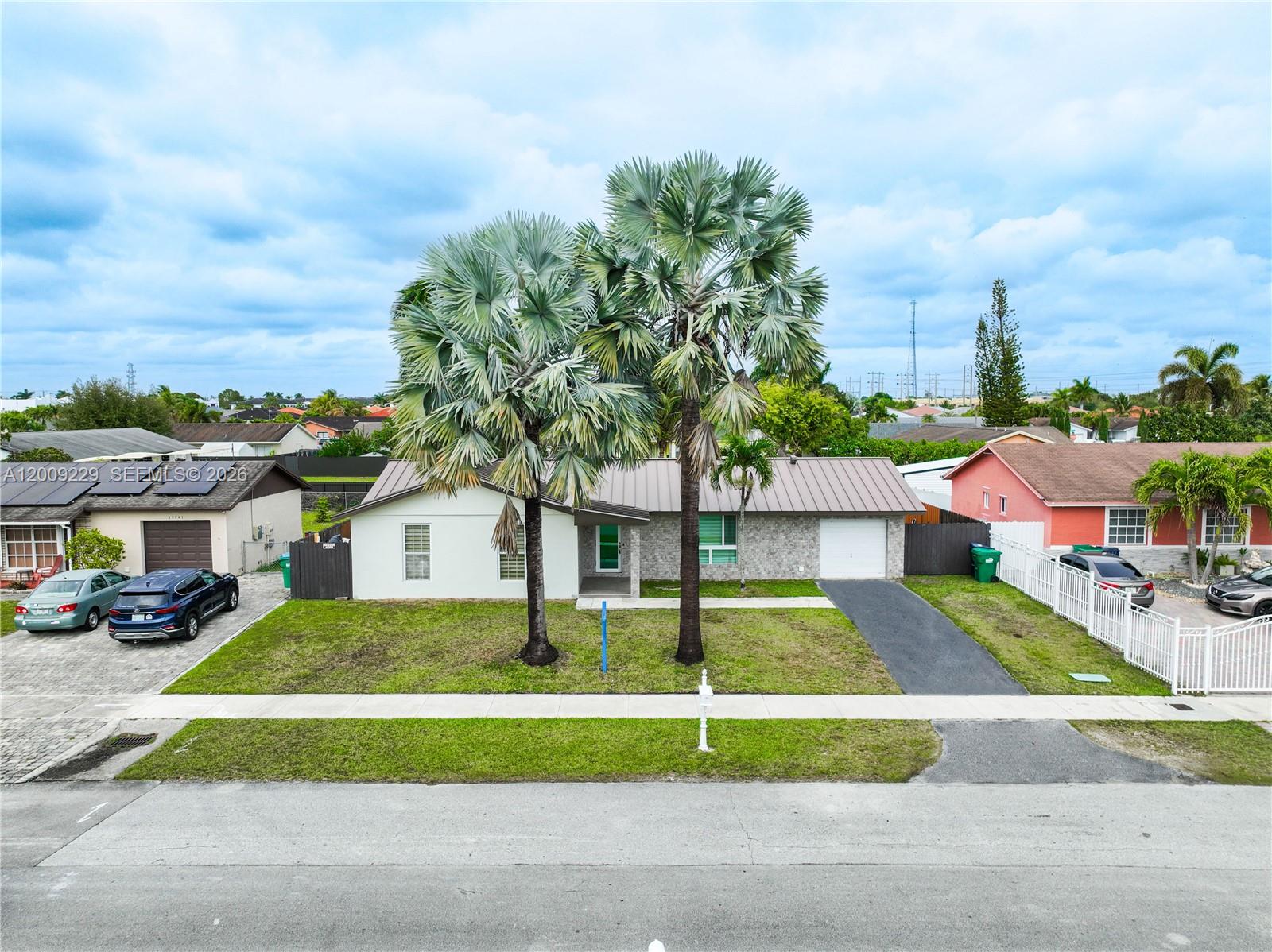 13251 Southwest 254th Terrace Homestead, FL 33032 - Photo 4 of 21 a front view of a house with a yard