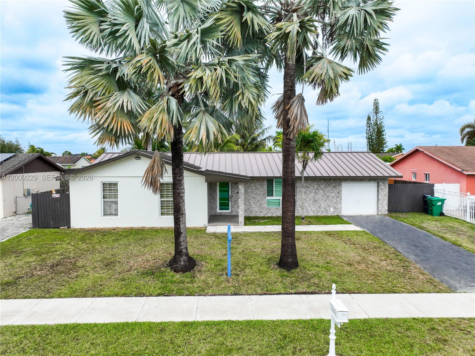 13251 Southwest 254th Terrace Homestead, FL 33032 - Photo 5 of 21 a front view of house with yard and green space