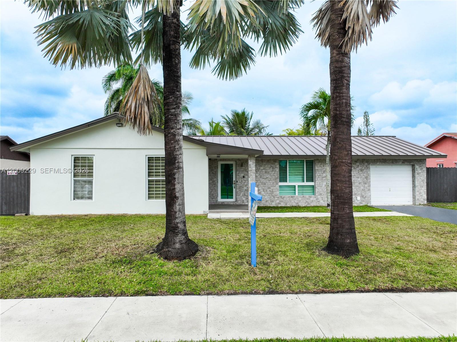 13251 Southwest 254th Terrace Homestead, FL 33032 - Photo 6 of 21 a house with a garden space