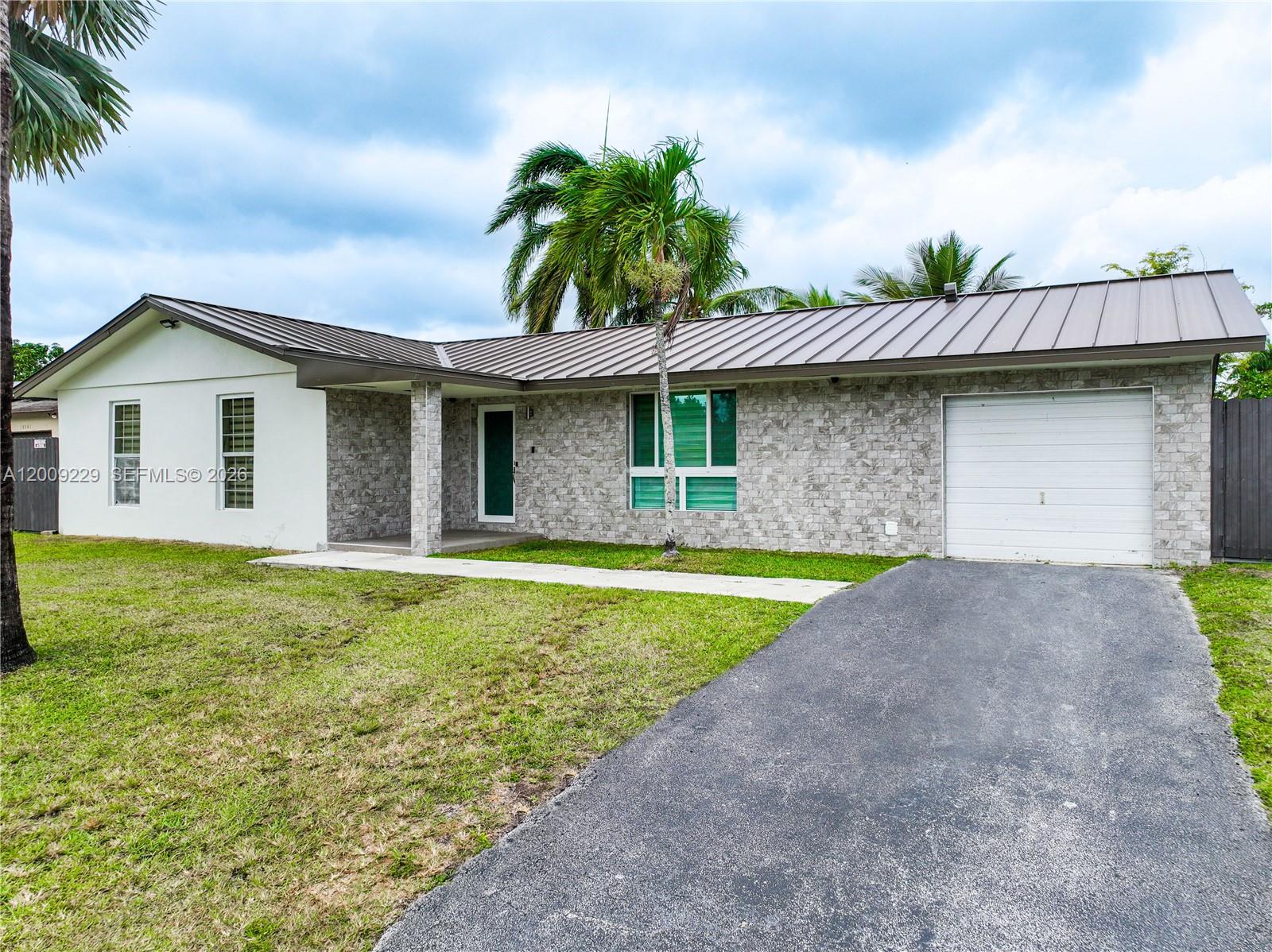 13251 Southwest 254th Terrace Homestead, FL 33032 - Photo 7 of 21 a front view of a house with garden