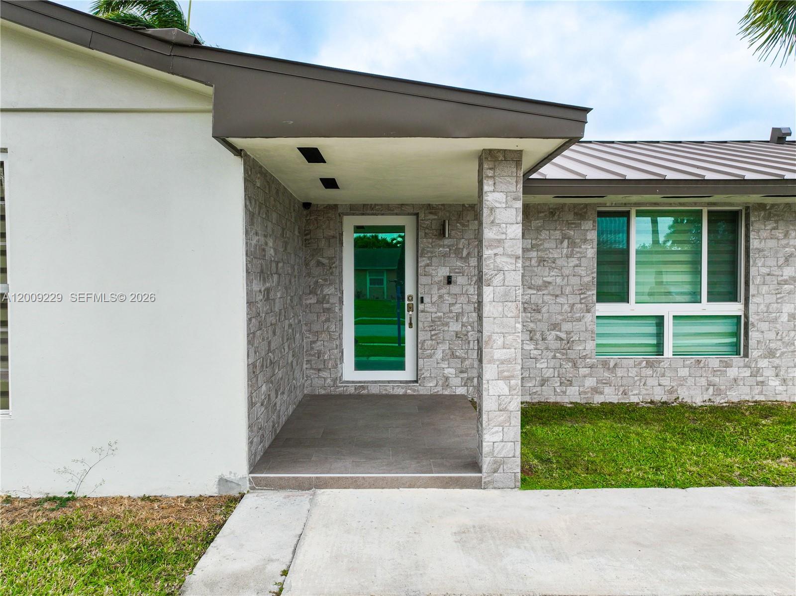 13251 Southwest 254th Terrace Homestead, FL 33032 - Photo 9 of 21 a front view of a house with a garden