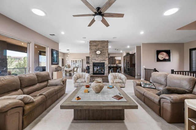 2376 Stone Crest Circle St. George, UT 84790 - Photo 8 of 61 Living room featuring ceiling fan, a stone fireplace, and recessed lighting