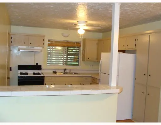 a bathroom with a tub a sink and a large mirror