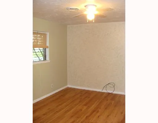 a view of a room with wooden floor and windows
