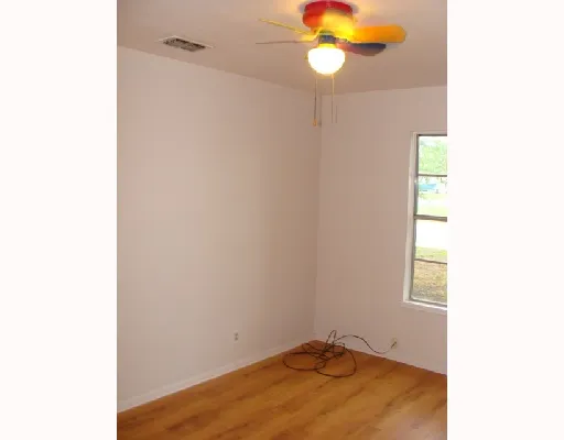 a room with a window and a fan