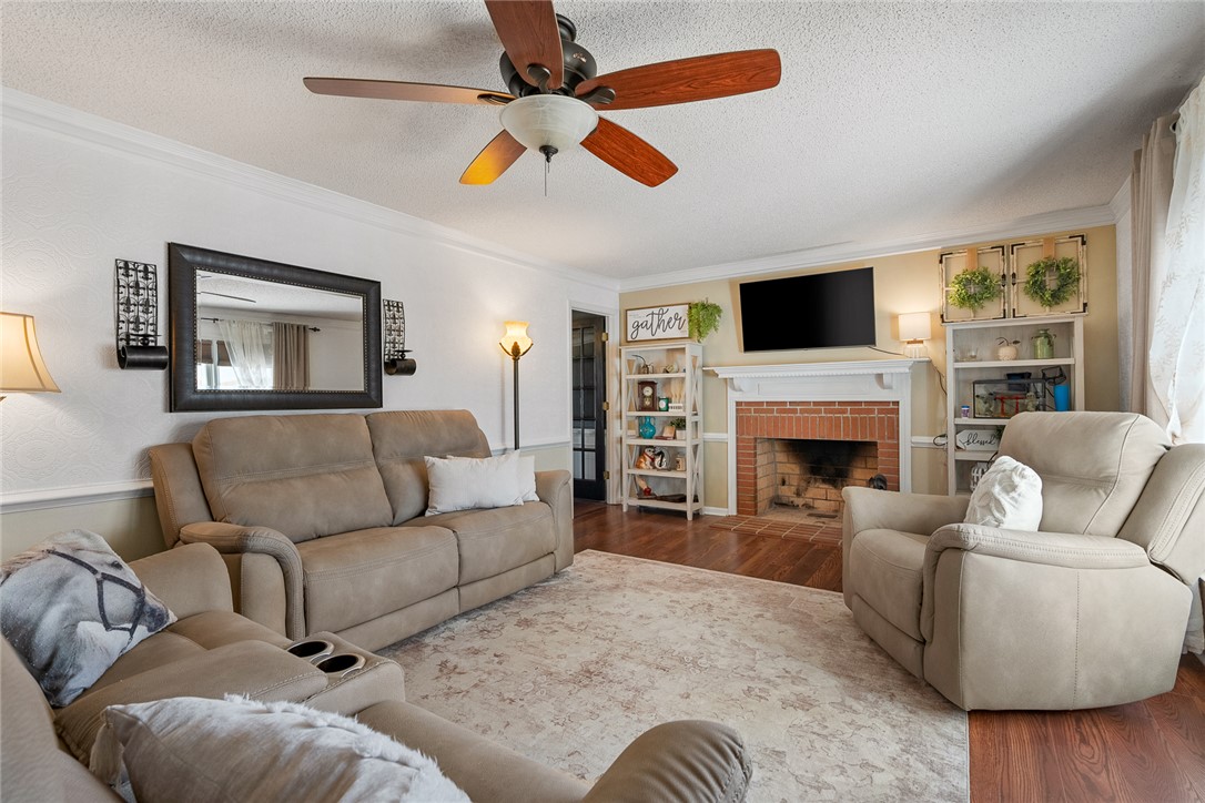 112 C-10-220 Anderson, SC 29621 - Photo 13 of 45 This living room features a fireplace and wood flooring, perfect for cozy gatherings.
