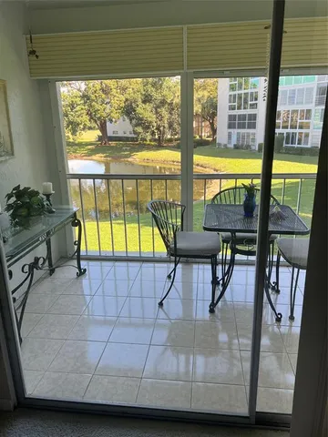 a view of a living room and a floor to ceiling window