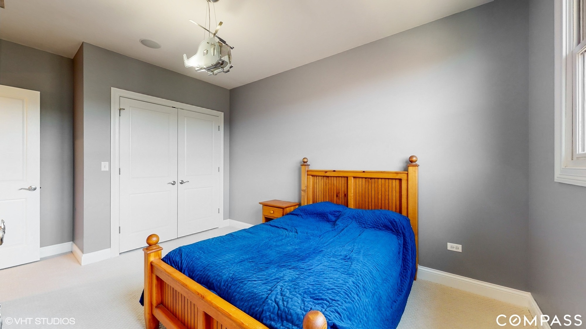 1412 South Emerald Avenue Chicago, IL 60607 - Photo 16 of 33 a bed room with a bed and a chandelier