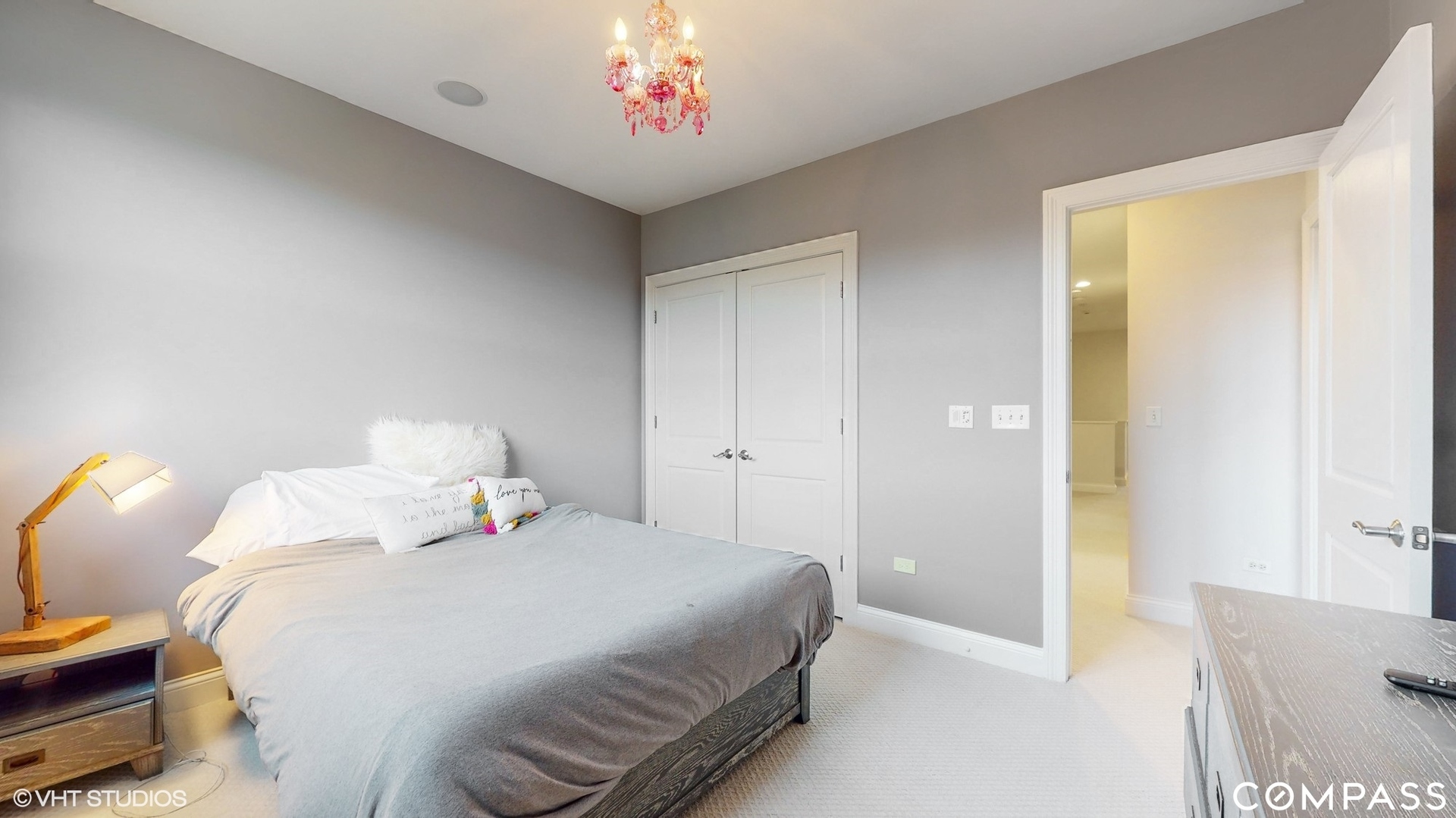 1412 South Emerald Avenue Chicago, IL 60607 - Photo 18 of 33 a bedroom with a bed and a chandelier