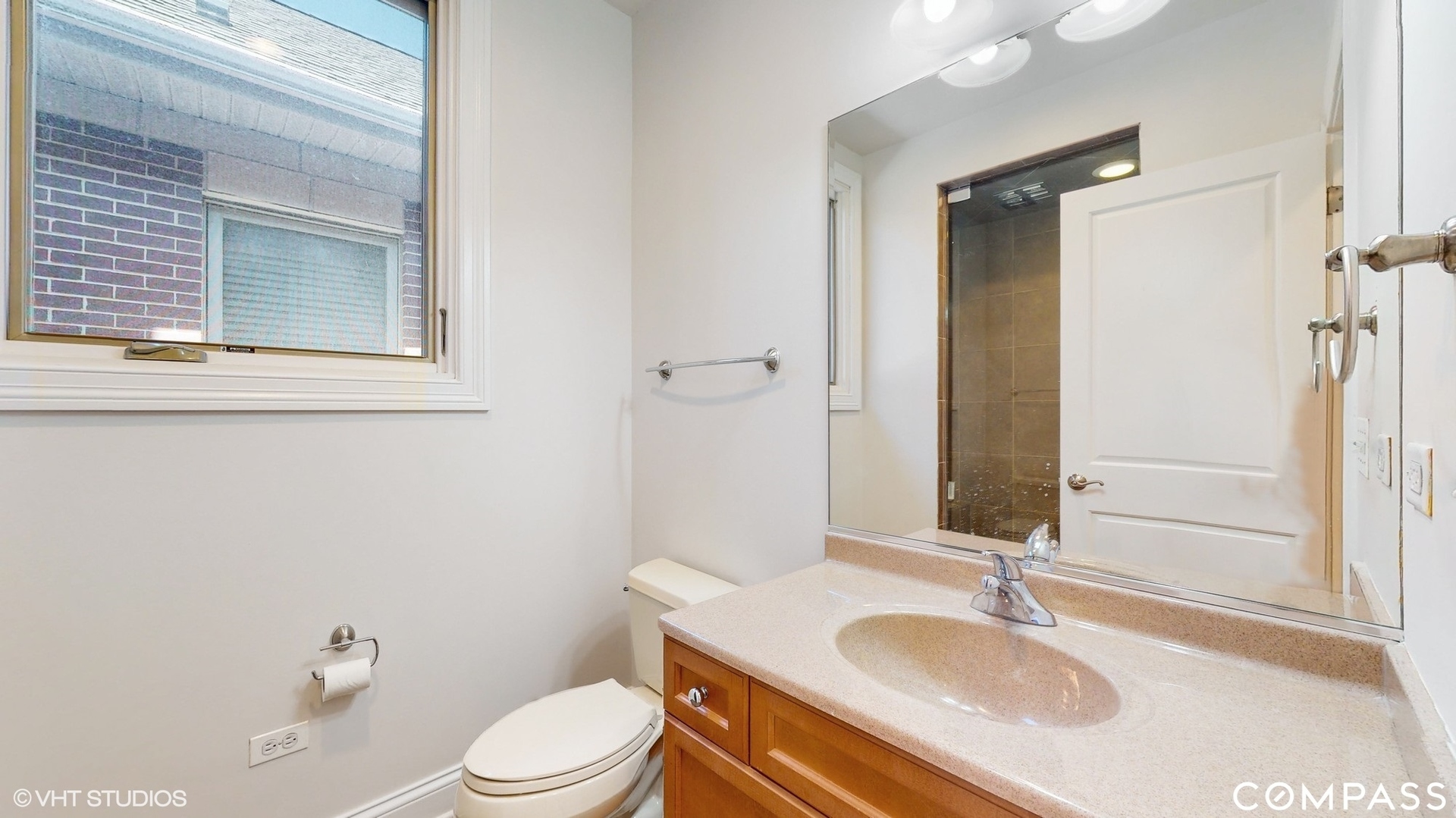 1412 South Emerald Avenue Chicago, IL 60607 - Photo 19 of 33 a bathroom with a sink toilet vanity and shower