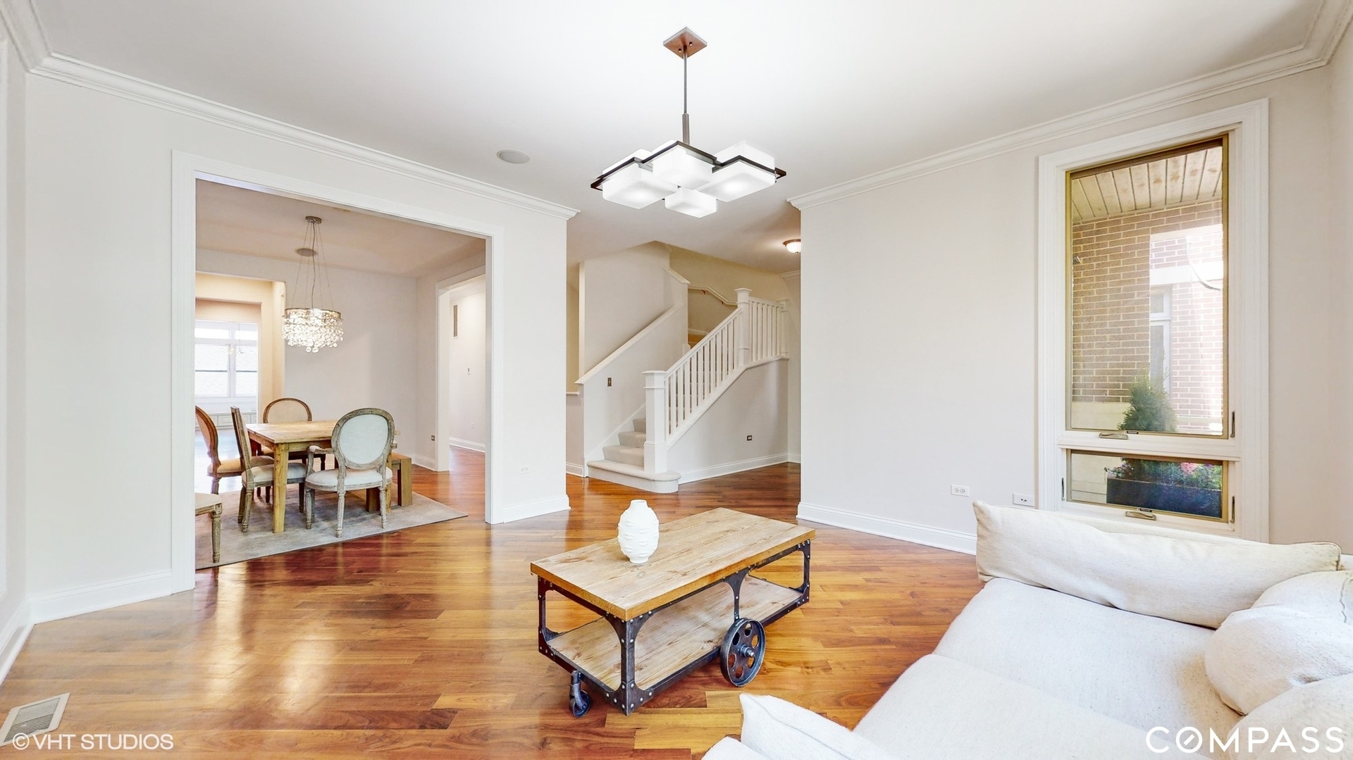1412 South Emerald Avenue Chicago, IL 60607 - Photo 3 of 33 a living room with furniture and a chandelier