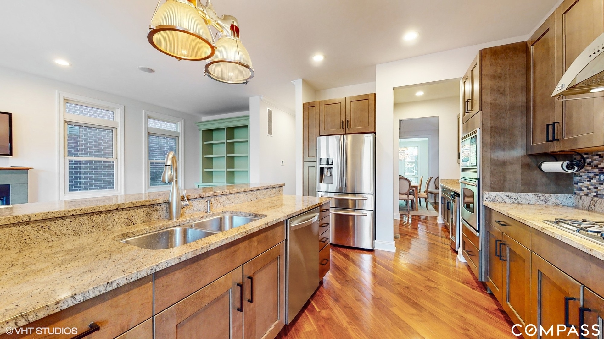 1412 South Emerald Avenue Chicago, IL 60607 - Photo 8 of 33 a large kitchen with stainless steel appliances a stove a sink a refrigerator and a dining table with wooden floor
