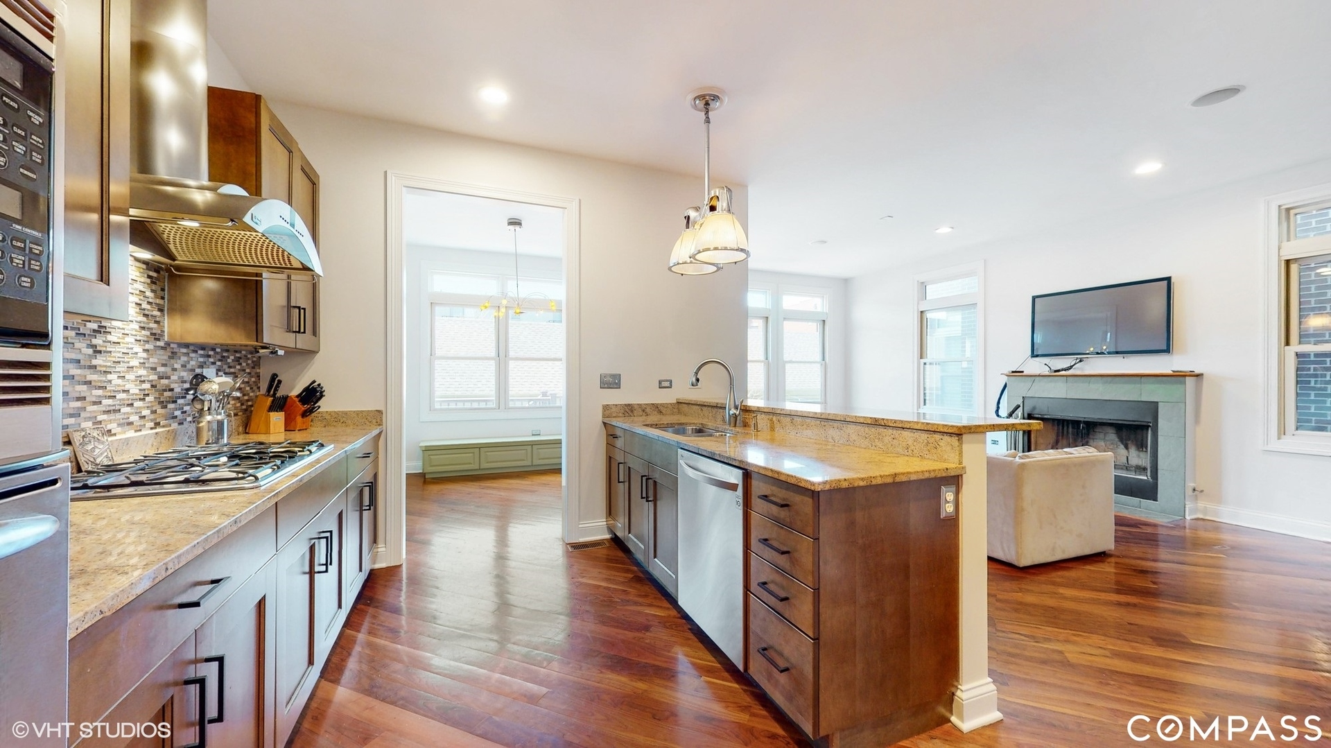 1412 South Emerald Avenue Chicago, IL 60607 - Photo 9 of 33 a kitchen with stainless steel appliances granite countertop wooden floors and sink