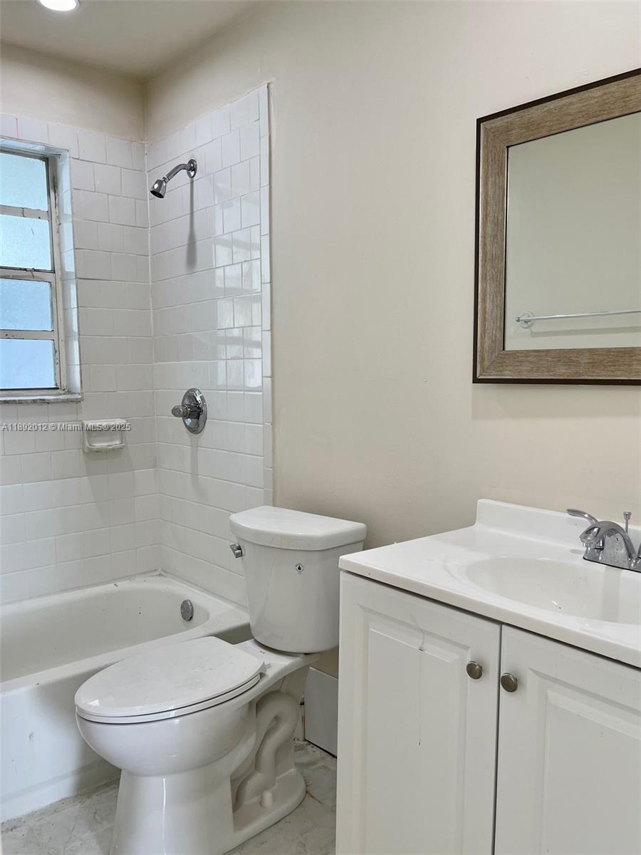 1725 West 60th Street, Unit F304 Hialeah, FL 33012 - Photo 15 of 26 a bathroom with a sink a toilet and shower