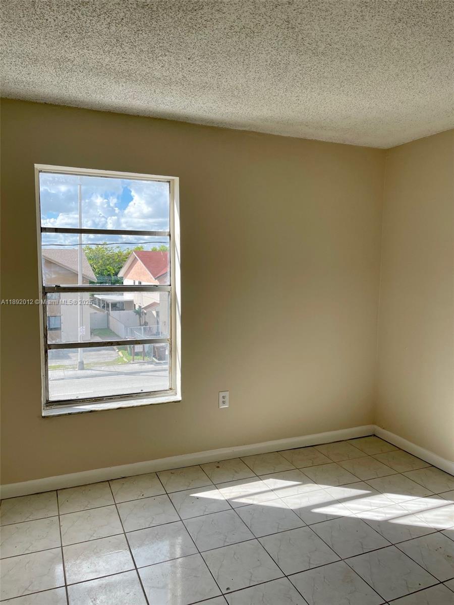 1725 West 60th Street, Unit F304 Hialeah, FL 33012 - Photo 16 of 26 a view of a room that has a window in it