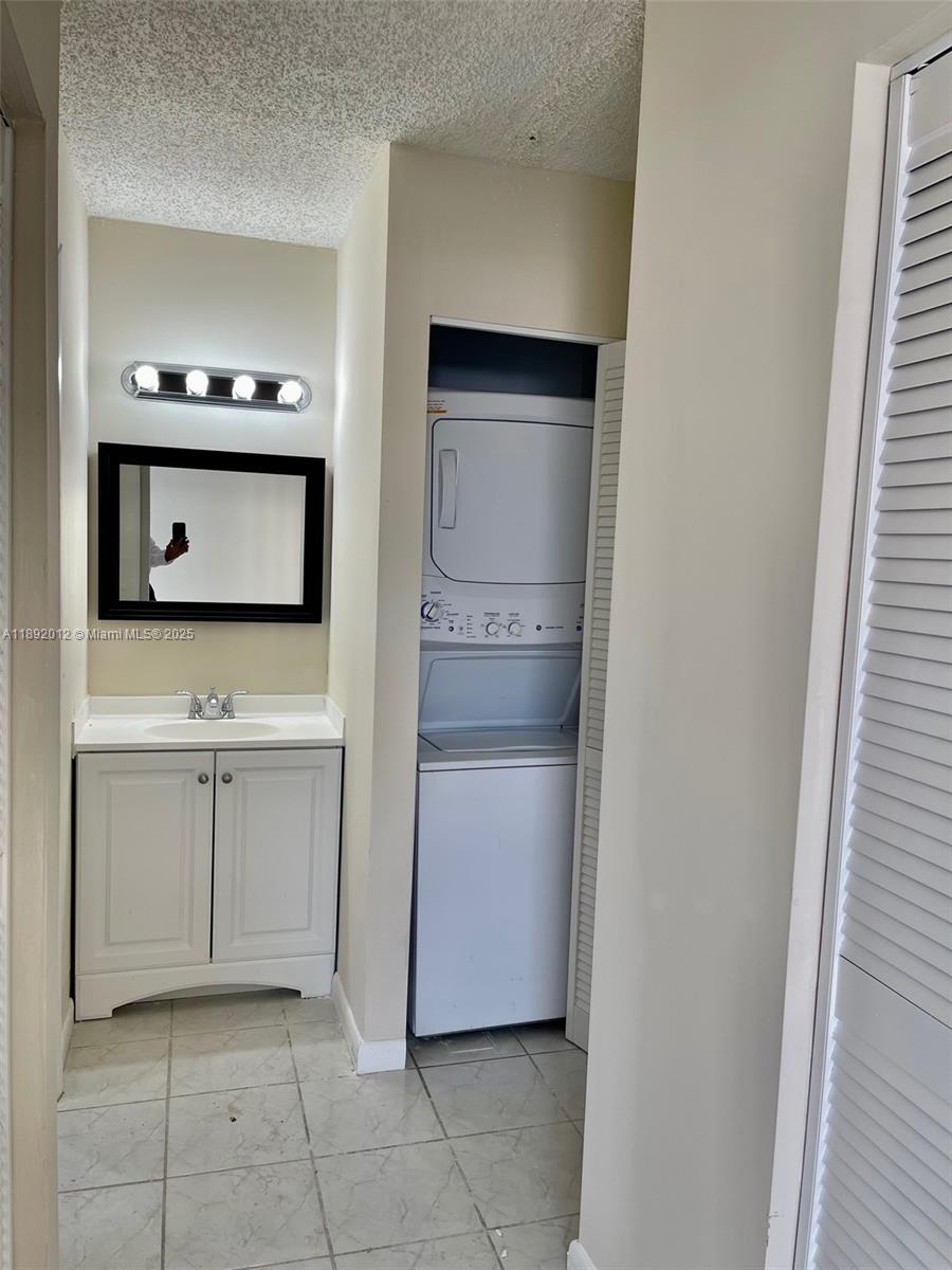 1725 West 60th Street, Unit F304 Hialeah, FL 33012 - Photo 18 of 26 a kitchen with white cabinets and white appliances
