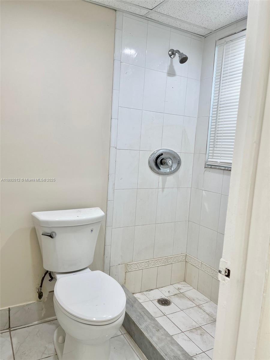 1725 West 60th Street, Unit F304 Hialeah, FL 33012 - Photo 19 of 26 a bathroom with a toilet and a shower