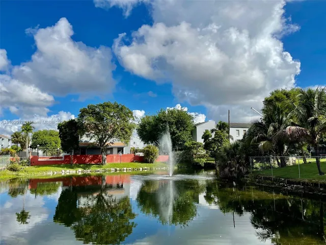 a front view of a house with a yard table and trees