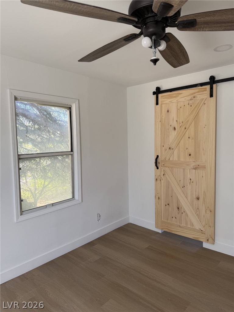1 Carson Court Ely, NV 89301 - Photo 10 of 20 This bright space features a practical barn door and wood flooring.