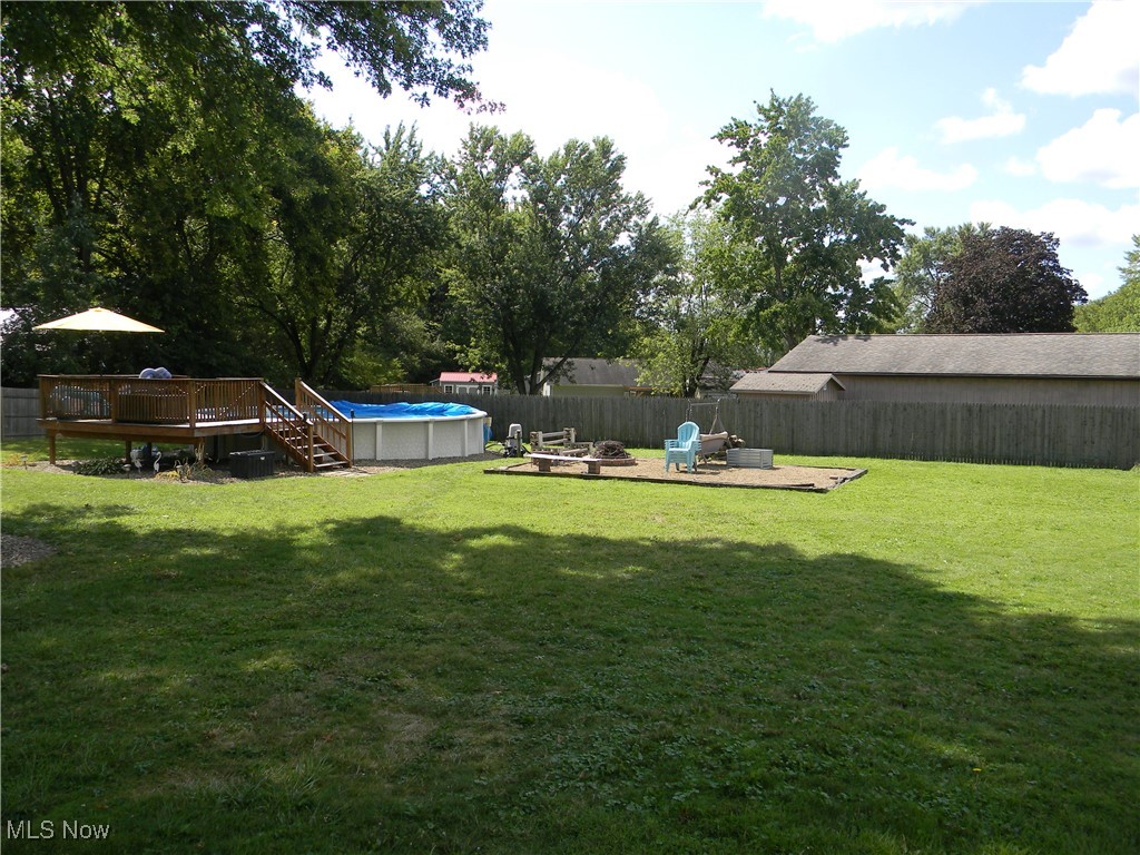717 State Road Northwest Warren, OH 44483 - Photo 30 of 37 View of yard featuring a swimming pool side deck and a fire pit