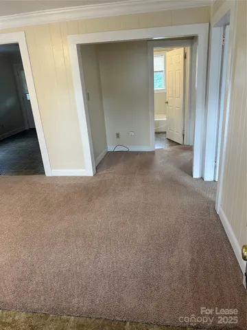 a view of an empty room and a window