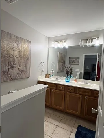 a spacious bathroom with a sink and mirror with shower