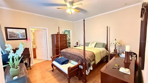 a bed room with a bed window and a chandelier