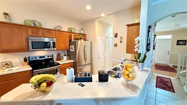 a kitchen with stainless steel appliances granite countertop a stove refrigerator and a sink