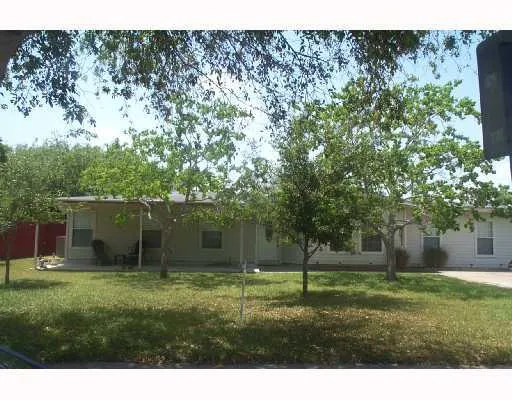 a view of a backyard with large trees