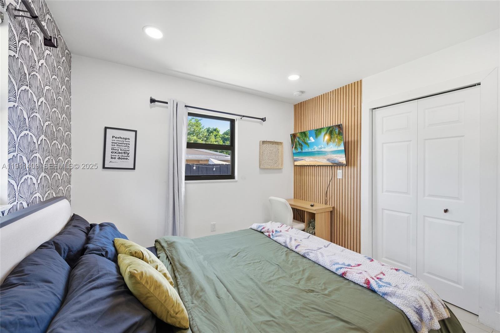 1464 Northeast 28th Street Pompano Beach, FL 33064 - Photo 24 of 51 a bedroom with a bed and wooden floor