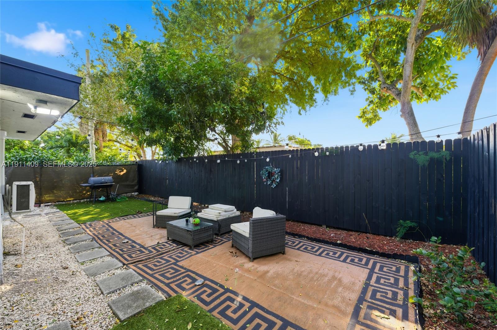 1464 Northeast 28th Street Pompano Beach, FL 33064 - Photo 41 of 51 a view of a backyard with sitting area