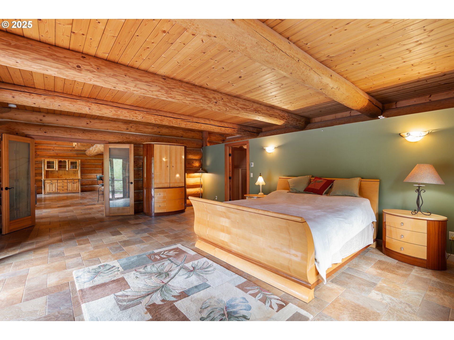 39582 Little Fall Creek Road Fall Creek, OR 97438 - Photo 15 of 44 a spacious bedroom with a bed and a lamp