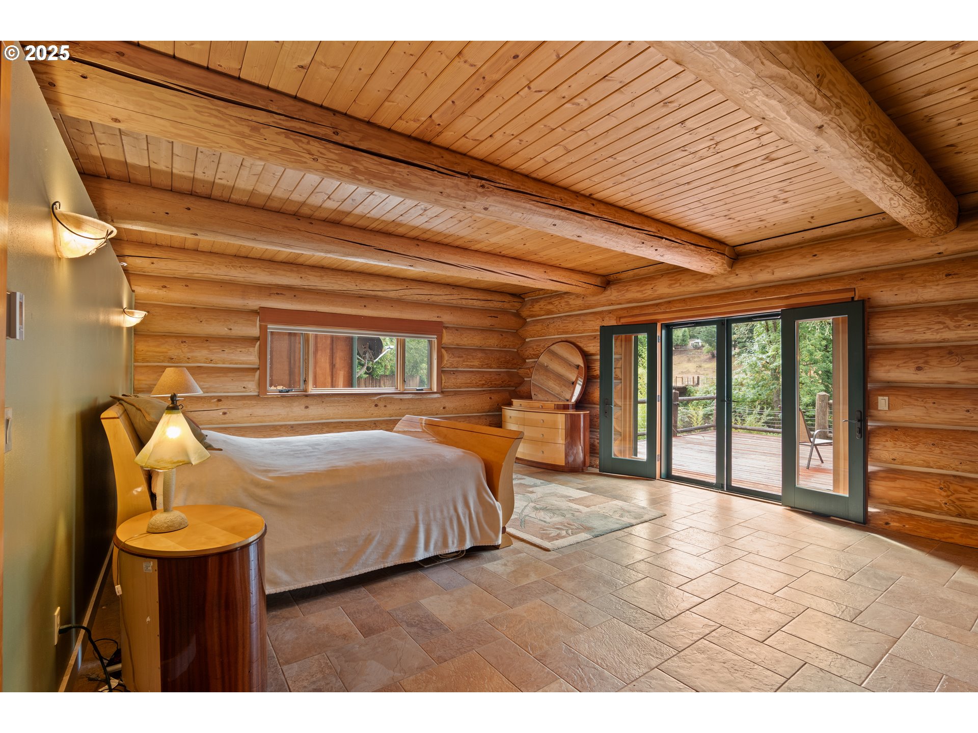 39582 Little Fall Creek Road Fall Creek, OR 97438 - Photo 16 of 44 a bedroom with a bed and a large window with outer view
