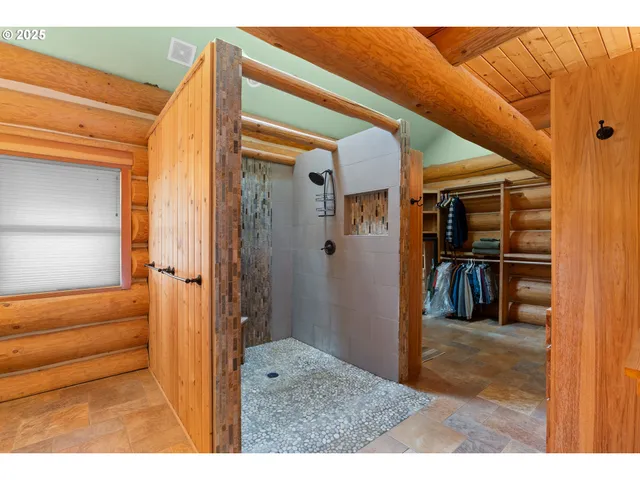 a view of a hallway with wooden floor and a living room
