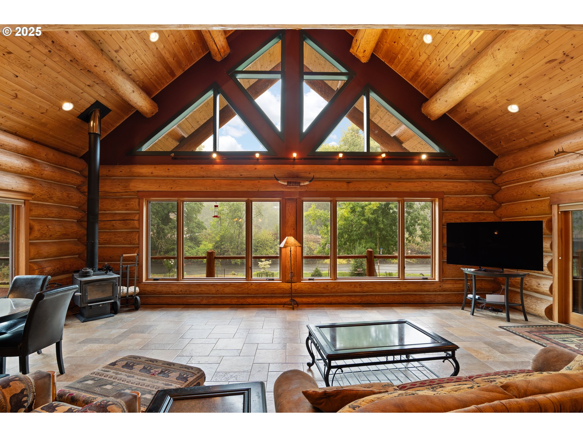 39582 Little Fall Creek Road Fall Creek, OR 97438 - Photo 7 of 44 a living room with furniture a flat screen tv and a large window